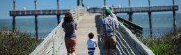 family walking on pier